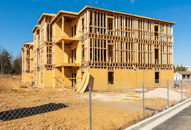 a temporary chain link fence in front of a building under construction, ensuring public safety in Liverpool TX